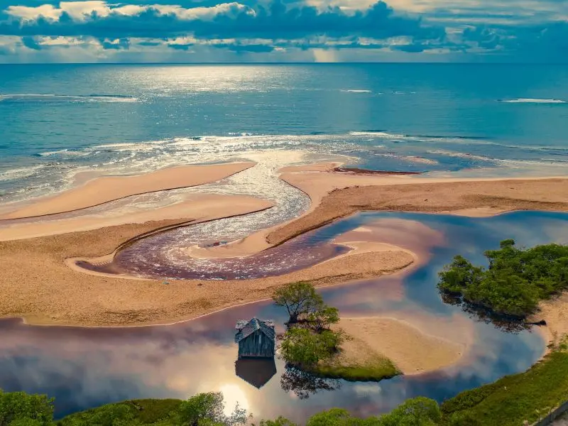 Orla da Praia de Trancoso, com uma pequena casa no meio da areia